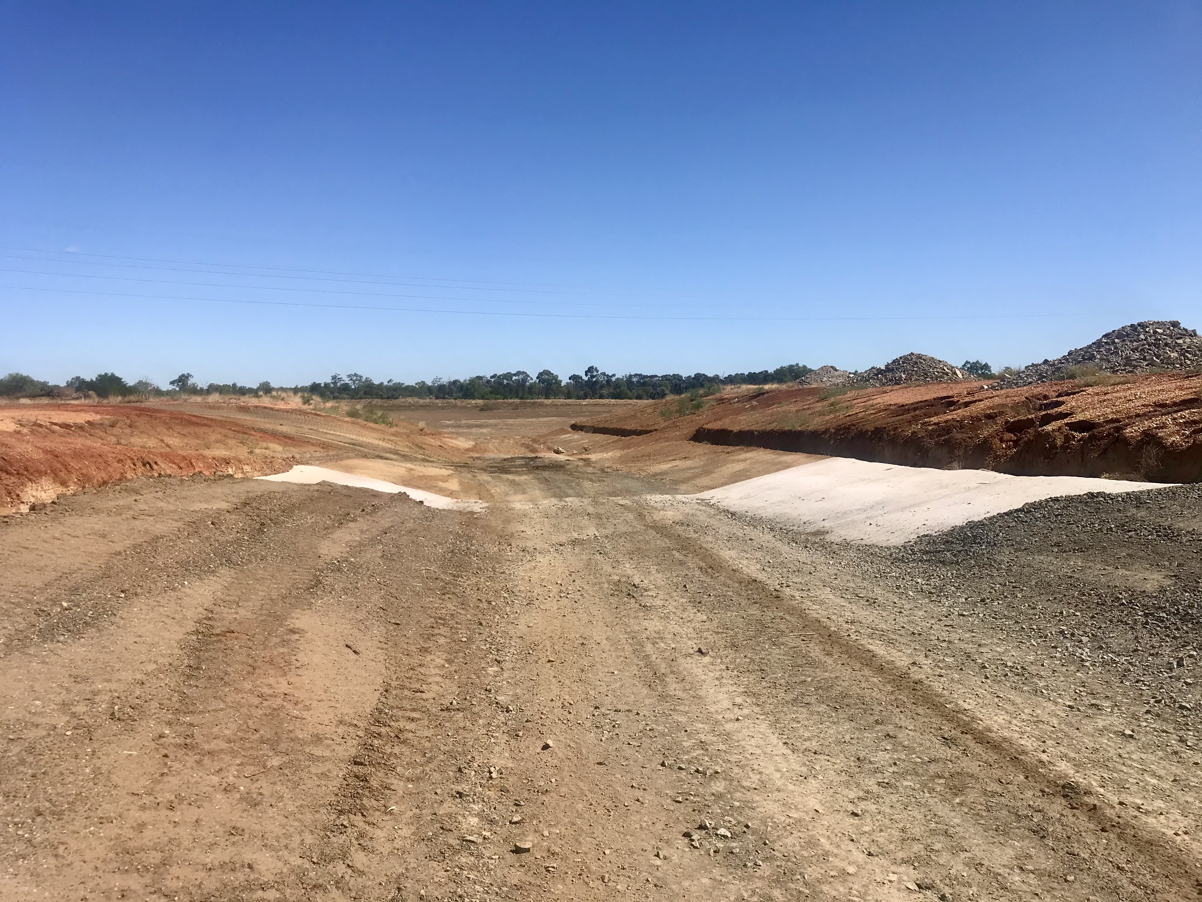 Road construction through red earth terrain in Central Queensland by HE Earthmoving